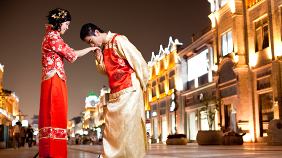 世界のバレンタインデーに関するブログのイメージフォト。台湾のバレンタインデーを説明する画像。中国の民族衣装カップル。男性が女性の手にキス。